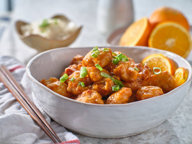 istock bowl of chinese orange chicken on table top 1276549291