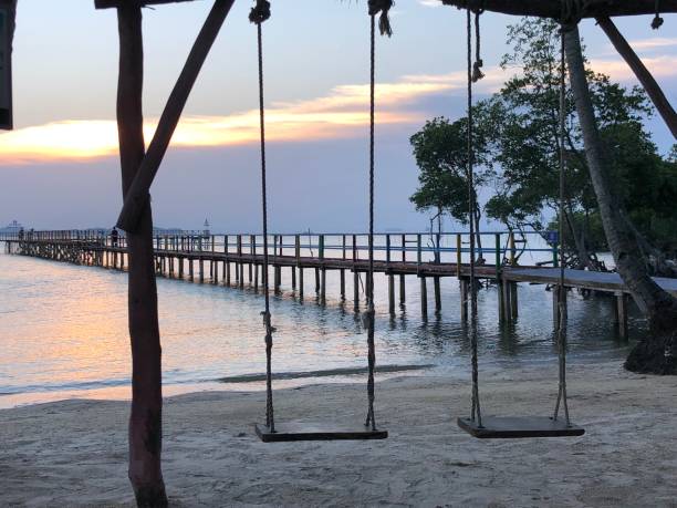 istock Swing on the beach at sunset, Batam, Indonesia 1276549318