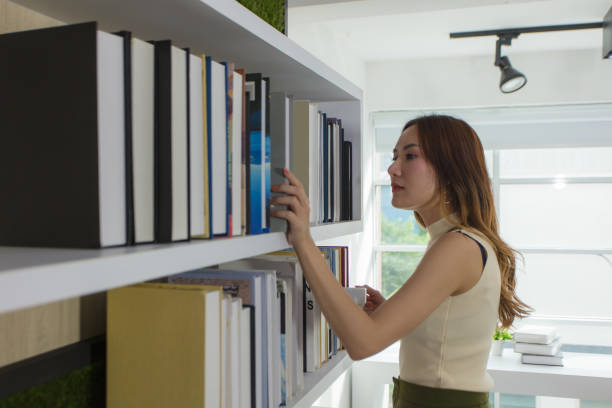 istock High school students search for books on bookshelves to make reports. 1276552045