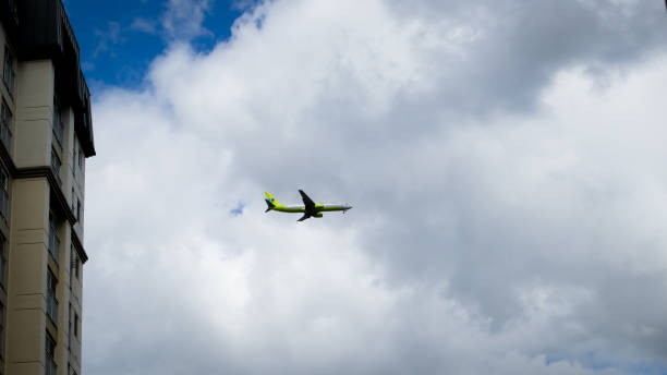 B737 aircraft fly over the cloudy sky stock photo