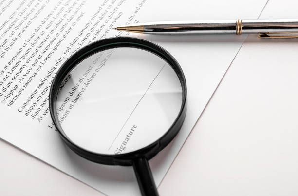 istock Signaure line in contract with pen and magnifying glass 1276557873