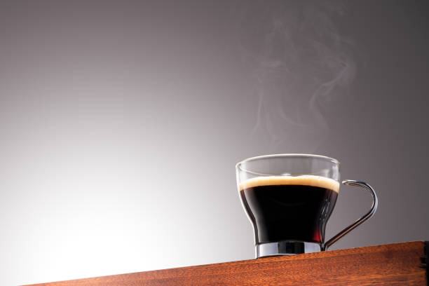 Close up photo of a coffee cup on a Wooden Surface and Gradient Background With Clipping Path