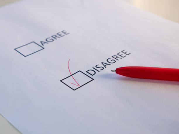 istock Agree and disagree check boxes on the white sheet mark agree with red pen. 1276561356