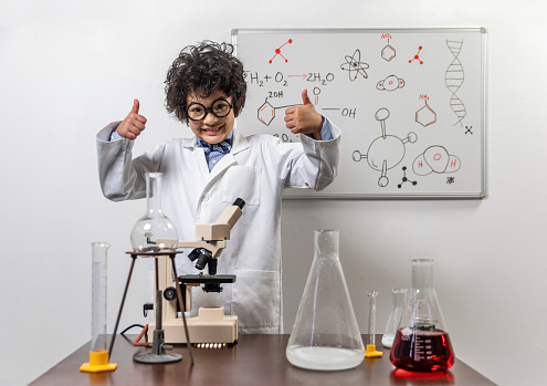 High quality stock photos of a child engaged in humorous spoof n a mad scientist and chemist in a mock laboratory.