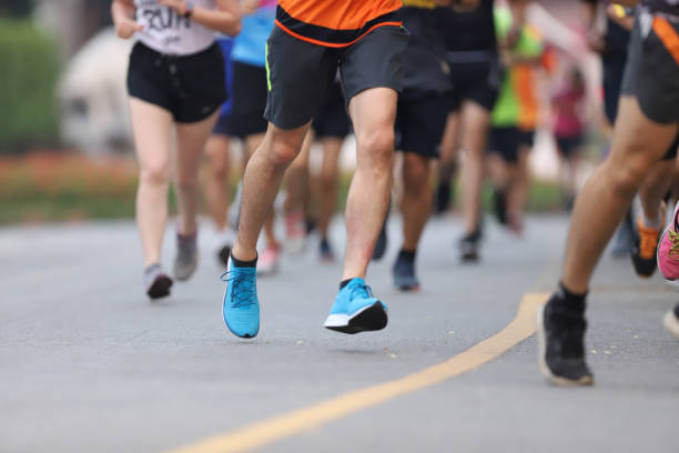 istock Group of people running race marathon 1276561657