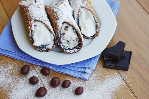 istock Traditional italian pastry called Cannolo on a plate on table 1276562730