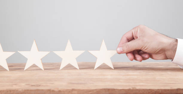 istock Male hand showing star rating. Customer service experience and satisfaction 1276562840