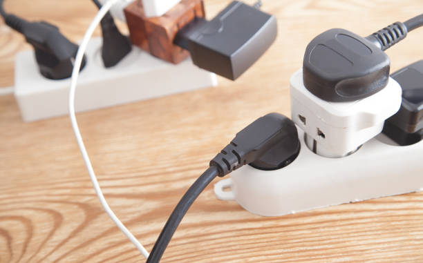 istock Different electrical plugs and chargers connected extension block. 1276562850