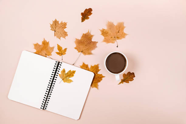 istock Flat lay composition with dry maple leaves, notebook and coffee latte cup on pink color background. Creative autumn, thanksgiving, fall, halloween concept. Top view, copy space 1276566475