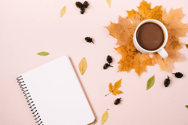 istock Flat lay composition with dry maple leaves, notebook and coffee latte cup on pink color background. Creative autumn, thanksgiving, fall, halloween concept. Top view, copy space 1276567052