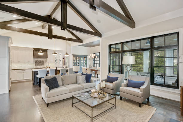 Wonderful open floorplan in new luxury home with black trim windows Large a-frame ceiling beams give a tasteful look of elegance home showcase interior photos stock pictures, royalty-free photos & images