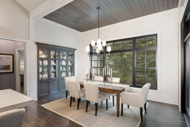 Luxurious dining area of fabulous home Wonderful built in china cabinet and wood panel ceiling add elegance dining room stock pictures, royalty-free photos & images