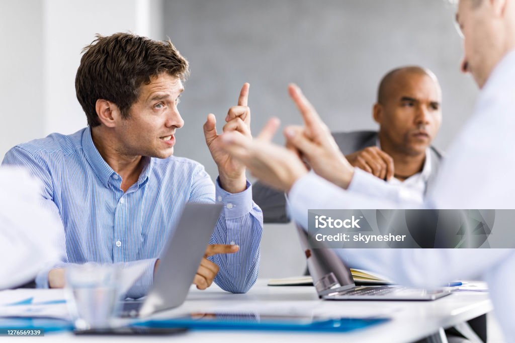 Communication problems on a business meeting! Frustrated entrepreneurs arguing during a business meeting in the office. Arguing Stock Photo