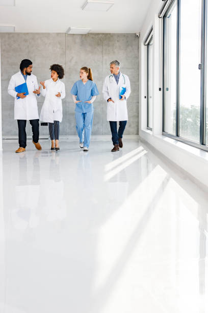 istock Group of doctors communicating on the move in a hospital. 1276569836
