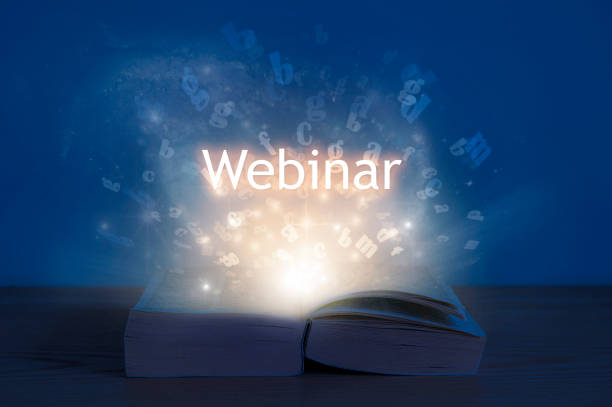 istock Webinar concept. Light coming from open book with word webinar. 1276569991
