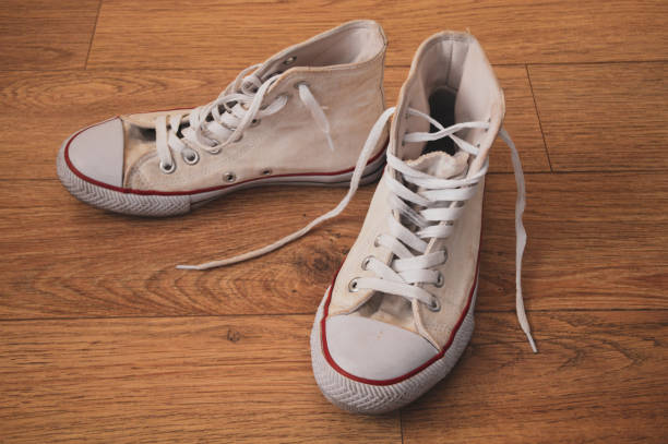 old white sneakers old white sneakers on the wooden floor running shoes on floor stock pictures, royalty-free photos & images