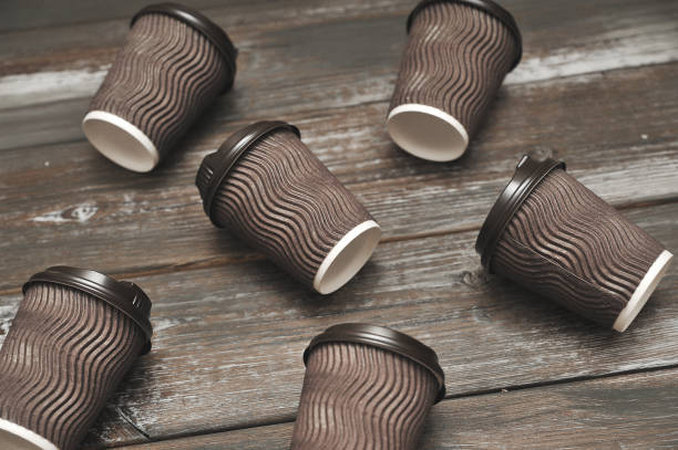 istock Brown paper cups for coffee on wooden background. 1276571963