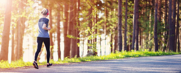 istock Young woman running in the park 1276572928