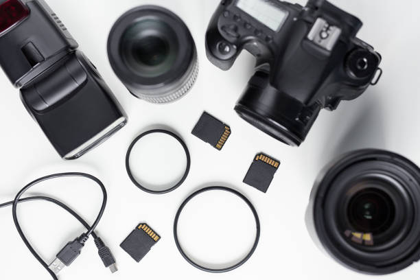 istock modern photo camera, lenses and equipment over white table 1276573955