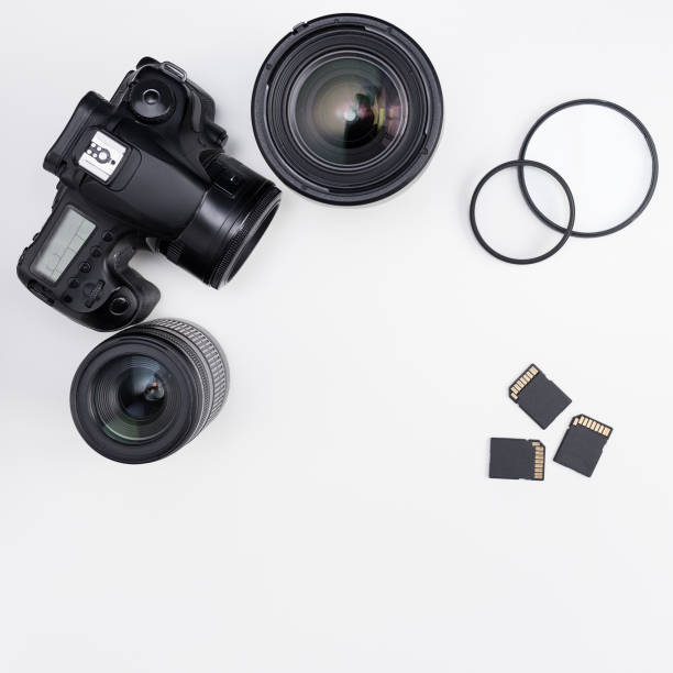 istock modern dslr camera, lenses, photo equipment and copy space over white table 1276573963