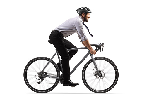 Profile shot of a businessman riding a bicycle with a helmet isolated on white background