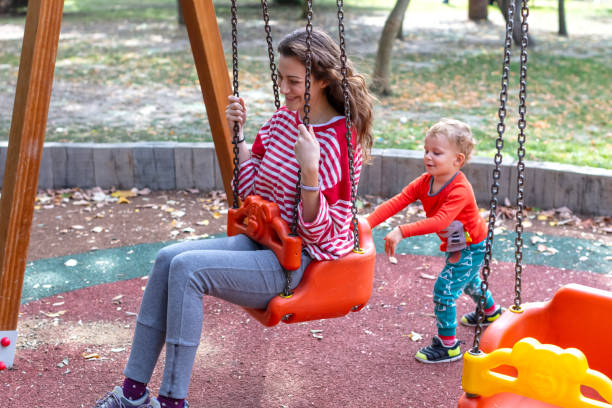 istock Son Swinging his Mother on a Swing 1276576321