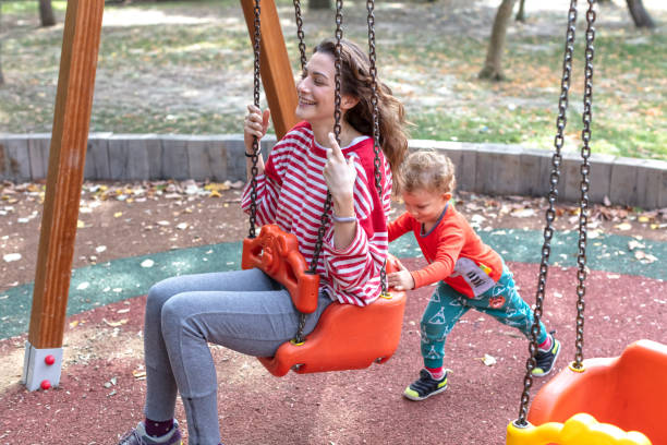 istock Son Swinging his Mother on a Swing 1276576696