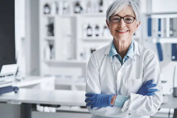 Portrait of a mature scientist standing with her arms crossed in a lab