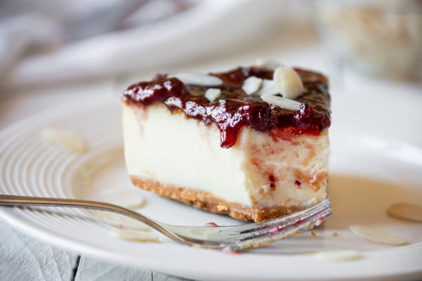 istock Homemade delicious cheesecake with fruit jam and almonds 1276579447