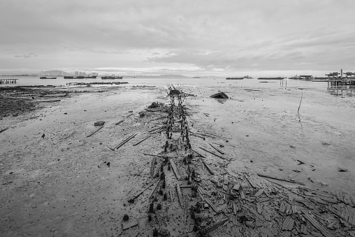 View of remains of the old pier at low tide, Tan Jetty, George Town, Penang, Malaysia. Black and white photography for printing.