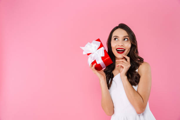 istock Cute pretty young asian woman holding gift box. 1276584332