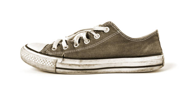 istock Old black sneaker isolated on white background 1276585611