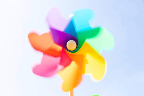 Moving coloured pinwheel on yellow background. Thematic lgtbq.