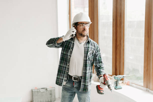 istock Construction worker in helmet talking on the phone 1276586248
