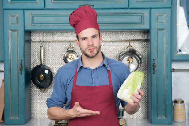 istock Cook man point hand at chinese cabbage 1276586317