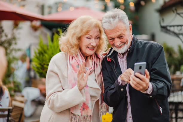 istock Lovely senior couple using mobile phone together 1276588669