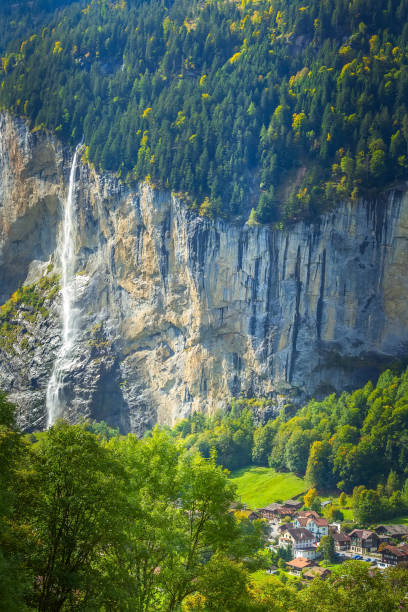 Lauterbrunnen waterfall, Staubbach, Switzerland Houses in Lauterbrunnen aerial view and waterfall in Swiss Alps, Jungfrau region, Staubbach Falls, Switzerland jungfrau stock pictures, royalty-free photos & images