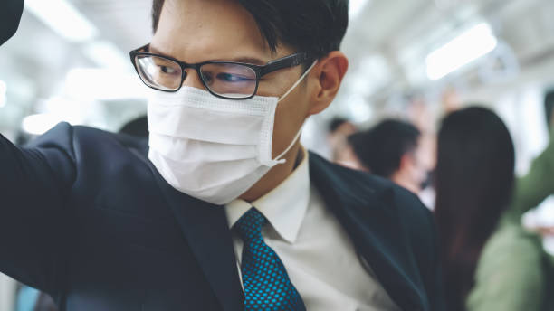 istock Young man wearing face mask travels on crowded subway train 1276588998