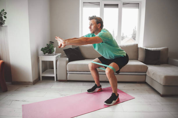 istock Caucasian man stretching and warming up at home while doing fitness 1276590292