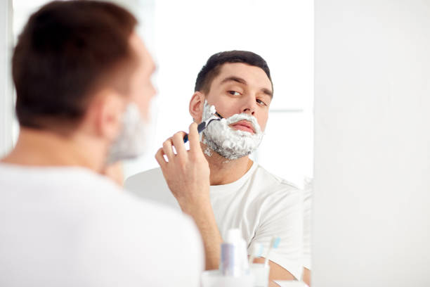 istock man shaving beard with razor blade at bathroom 1276591630
