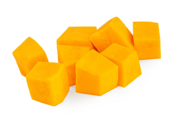 istock Pumpkin pieces cut in a cube chunks  isolated on white background. 1276592159