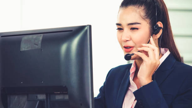 istock Business people wearing headset working in office 1276592281