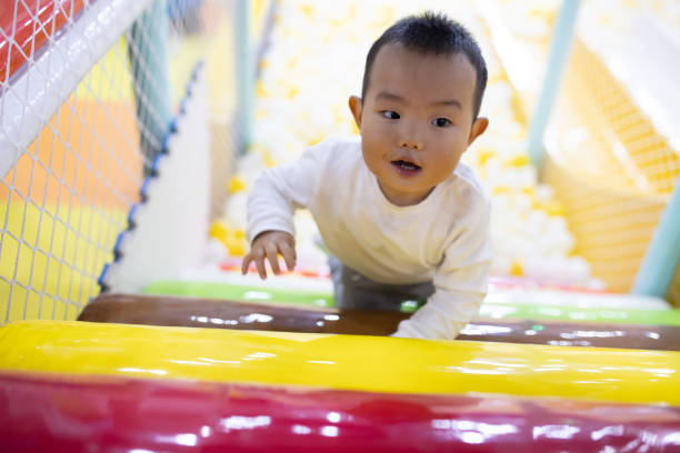 istock Baby boy climbing stairs in playground 1276592712