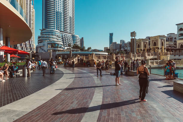 DUBAI, UAE - DECEMBER 12, 2018: Tourists and local people near Mall of Dubai. Tourist attracting Burj Khalifa. Busy tourist attraction area. Travel vacation concept