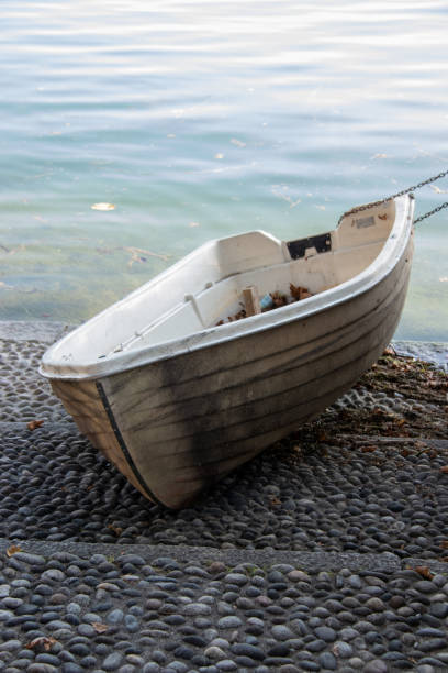 istock Little boat on the shore of Lake Como 1276593665