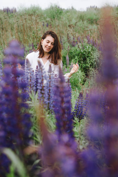 istock woman at blooming lupines field 1276595716