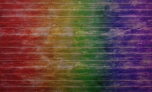 Wood planks with worn off surface painted in rainbow colors