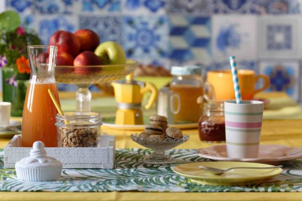 Table set for morning breakfast with food and props in sunny atmosphere