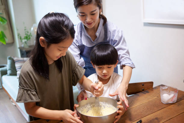 istock Mothers and children making sweets while watching recipes on a tablet 1276598178