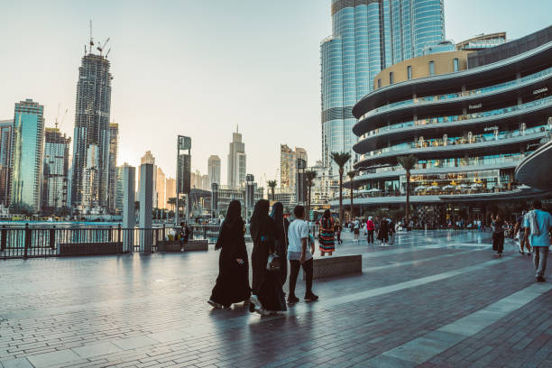 DUBAI, UAE - DECEMBER 12, 2018: Tourists and local people near Mall of Dubai. Tourist attracting Burj Khalifa. Busy tourist attraction area. Travel vacation concept
